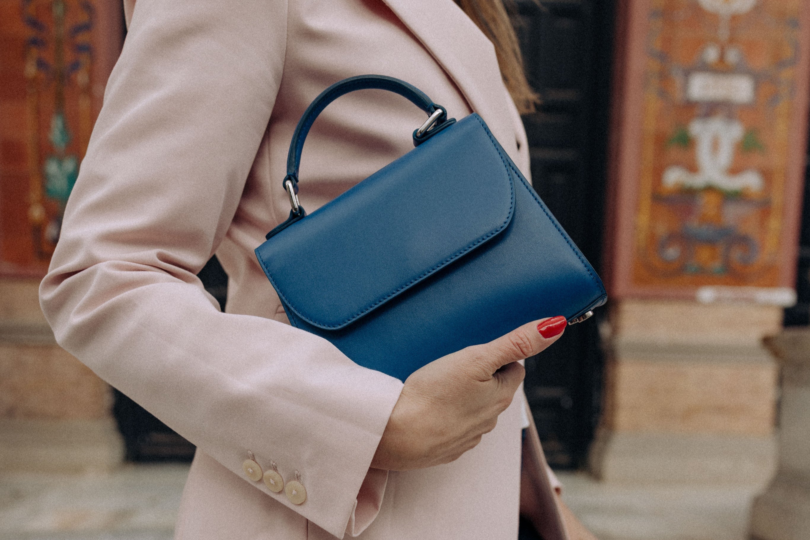 Woman holding VENI Handbag in indigo blue